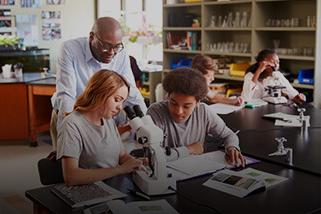 High school science teacher assisting students